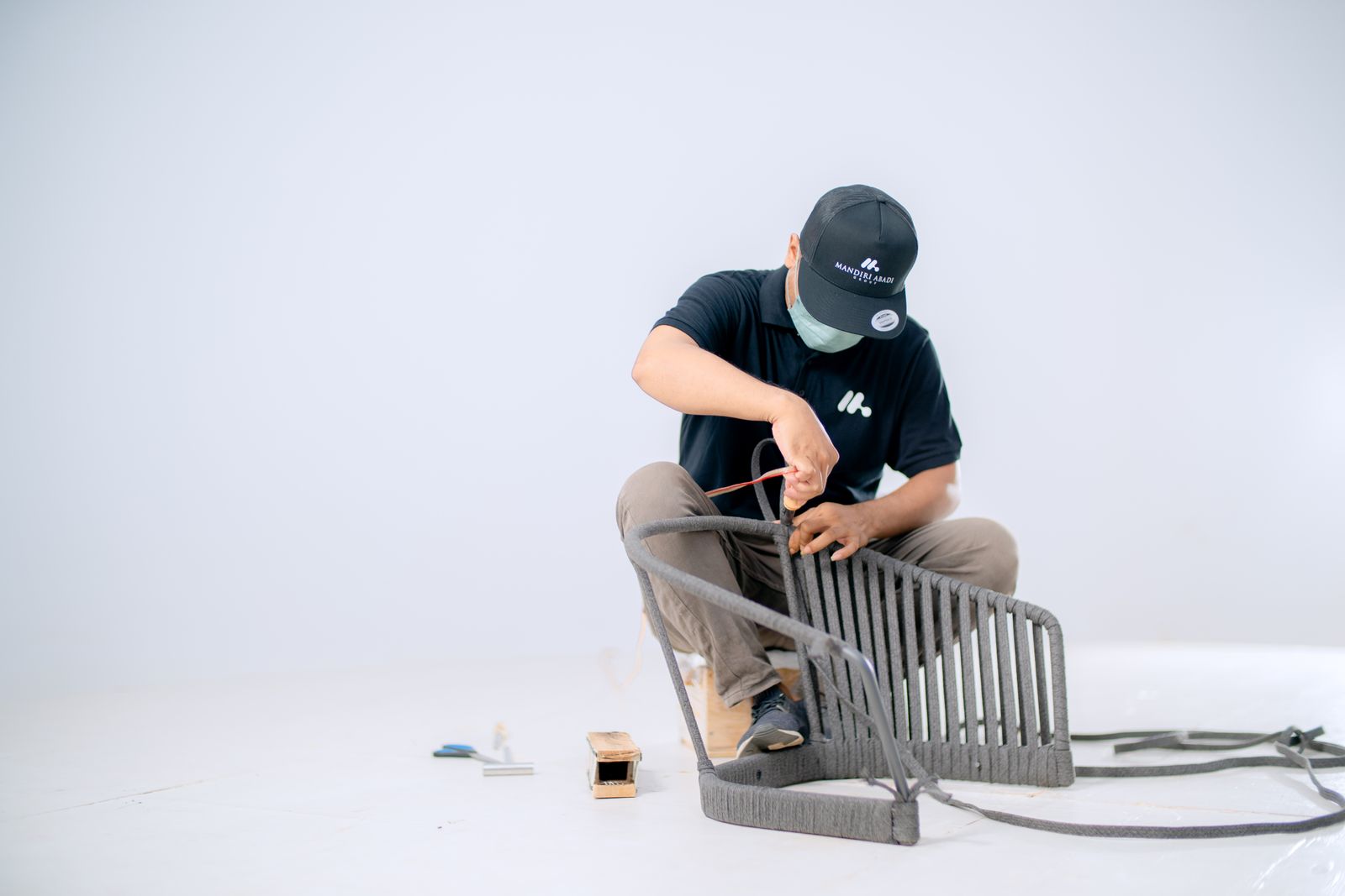 Craftsman assembling a wooden chair frame
